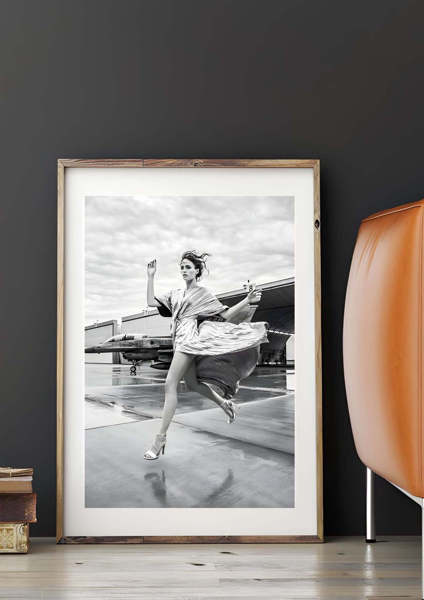 Black and White Fashion Wall Art featuring a woman running near a jet for modern home décor.