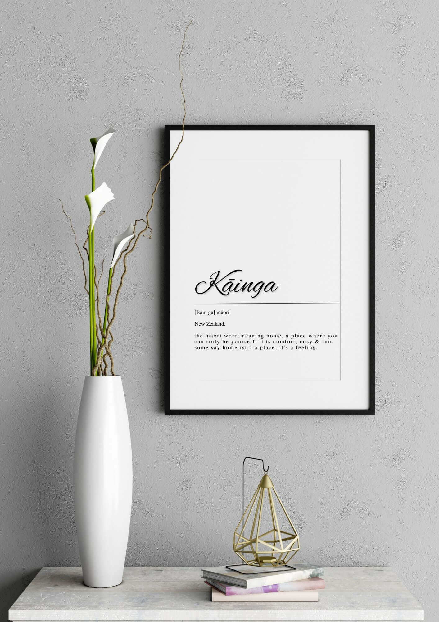 Minimalist wall art titled 'Kainga Māori Home Quote Printable Wall Art' framed on a modern decor wall next to a vase.