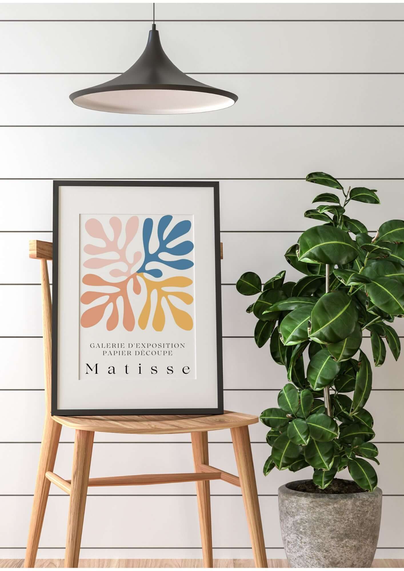 Matisse Inspired Cutout Abstract Wall Art with pastel hues and bold shapes on a chair, next to a plant, minimalist decor.