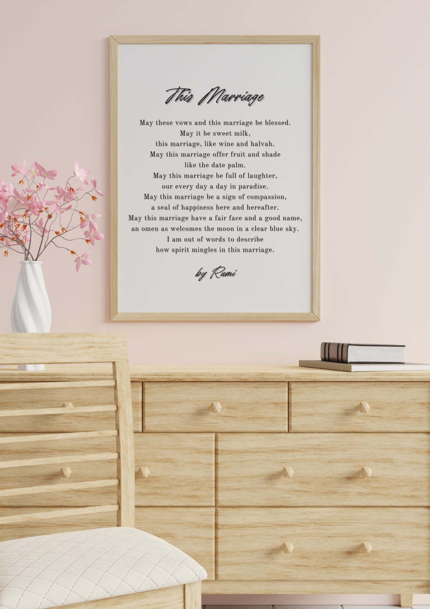 This Marriage Rumi Wedding Poem Wall Art displayed on a wall with wooden dresser and vase with pink flowers.