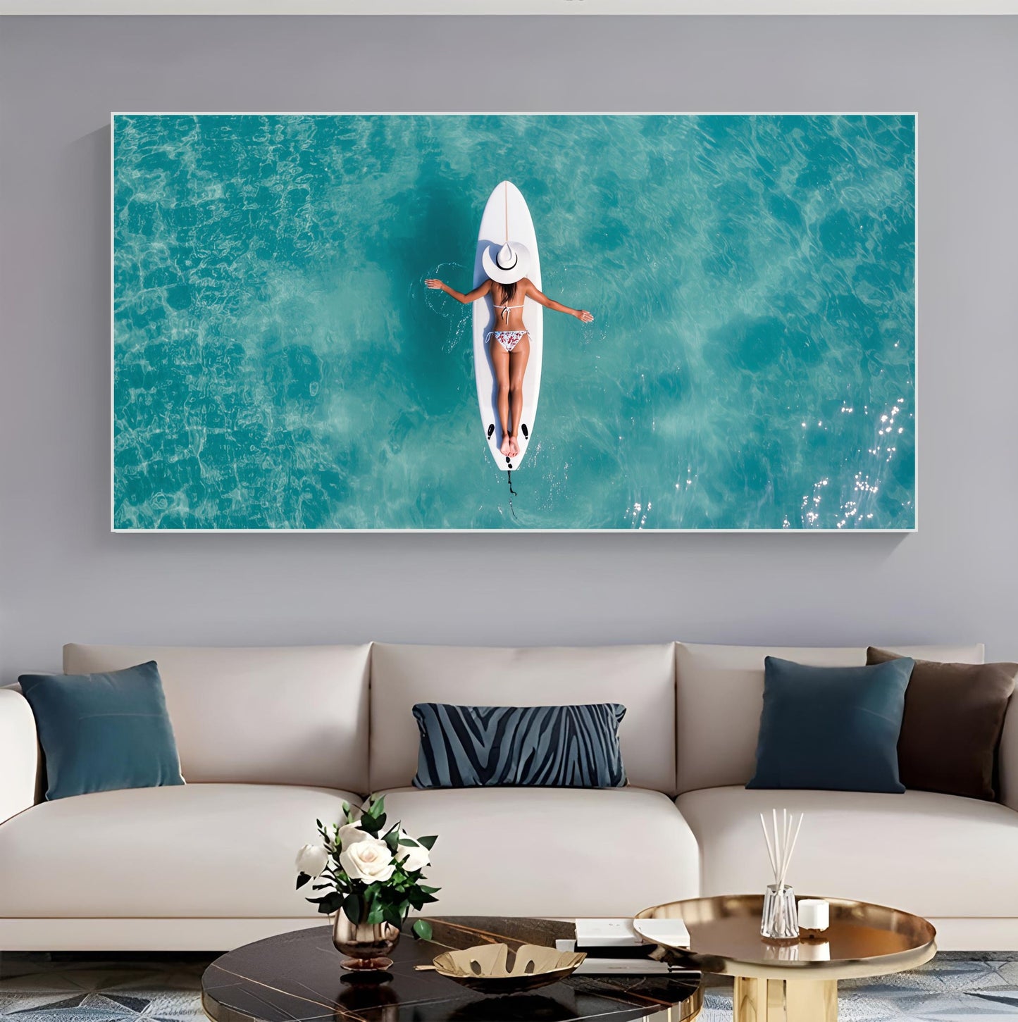 Surfboard Woman Aerial Ocean Print – Minimalist Beach Wall Art, serene décor of woman floating on turquoise waters in living room.