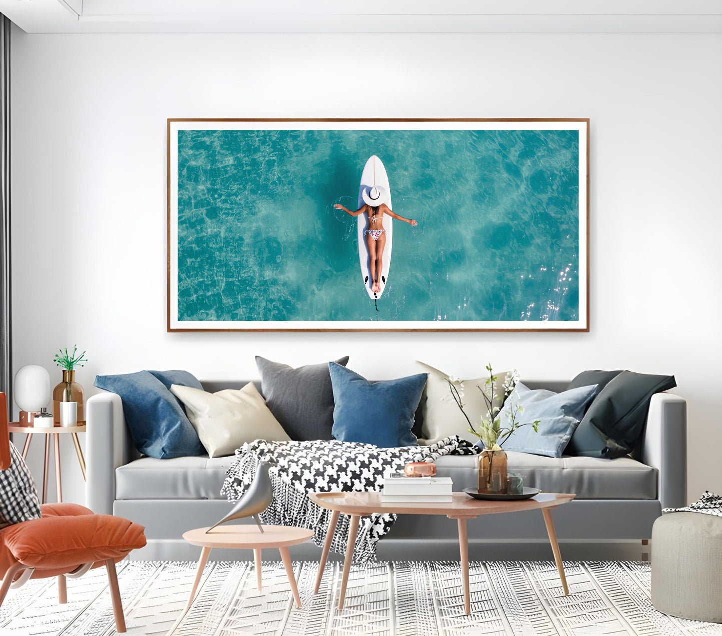 Surfboard Woman Aerial Ocean Print – Minimalist Beach Wall Art featuring a woman on a surfboard over turquoise water in a serene setting.