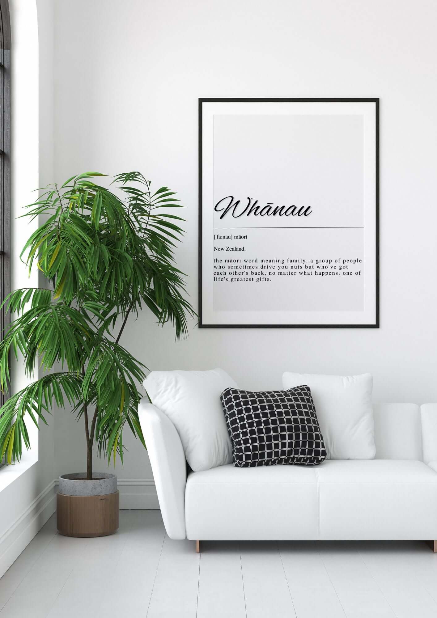 Whānau Māori Family Definition Printable Wall Art displayed in a modern living room with a potted plant and a white sofa.