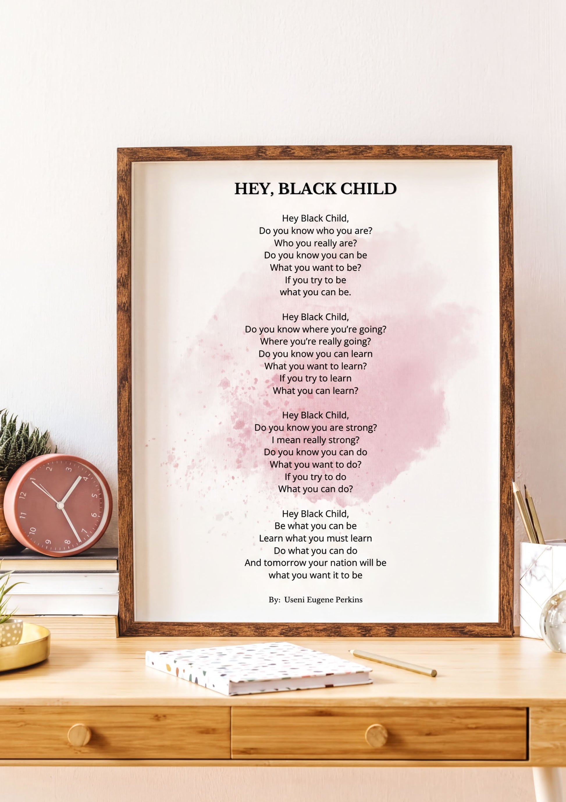 Hey Black Child Poem motivational poetry print framed on a desk, inspiring self-confidence and ambition.