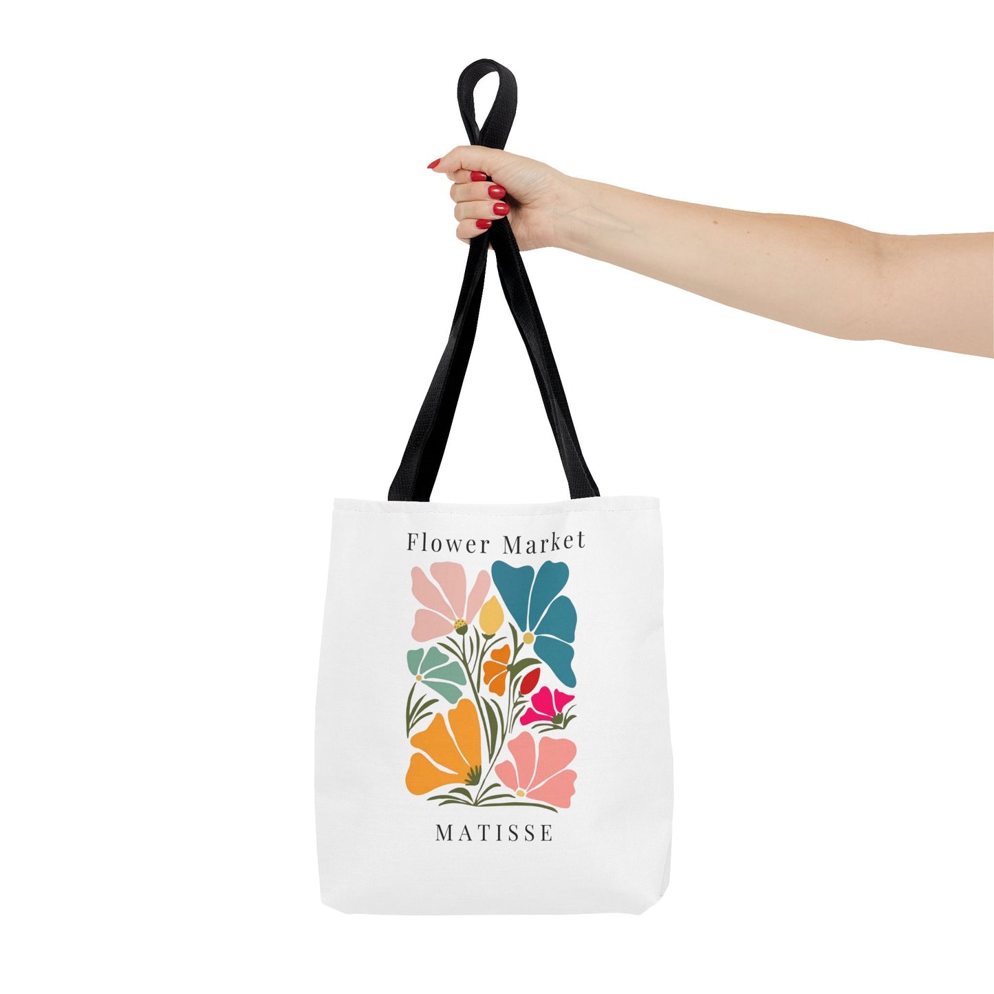 Woman holding Henri Matisse tote bag with artistic floral design and black handles, perfect for art lovers and daily use.