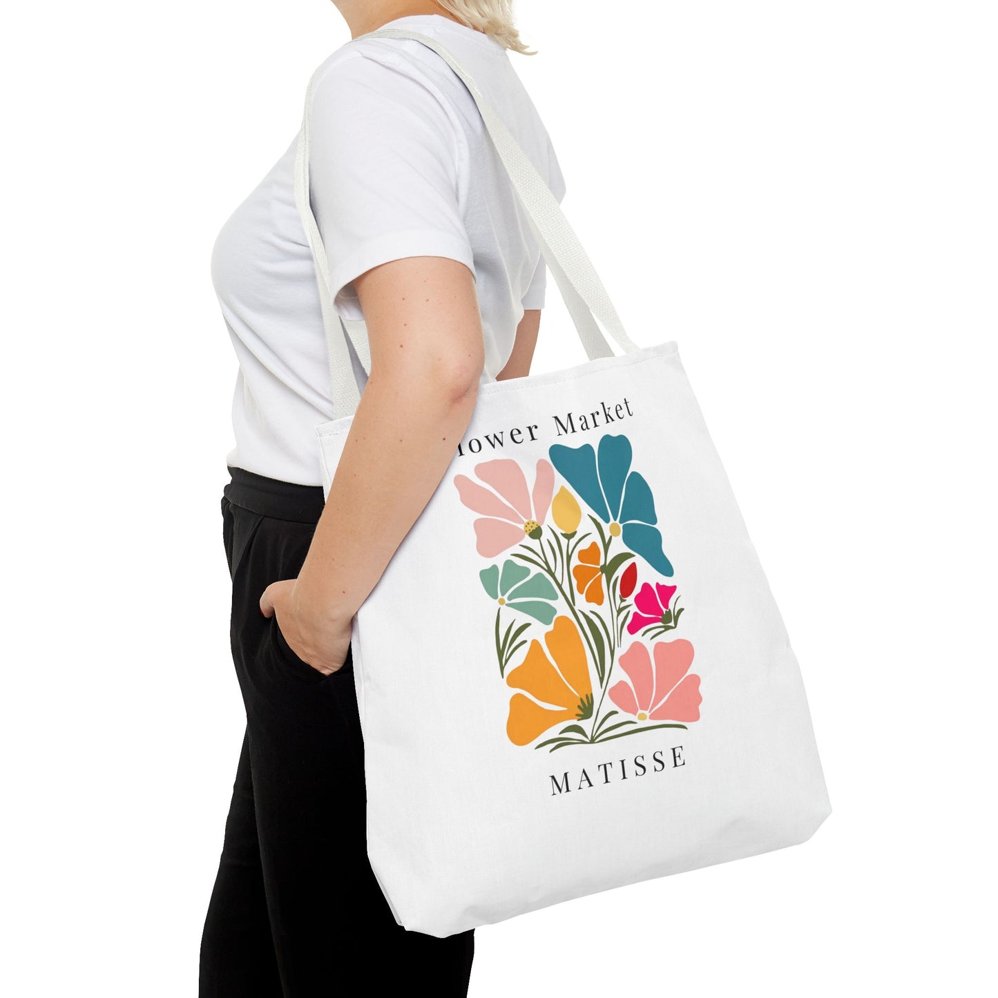 Person carrying a Henri Matisse tote bag with colorful artistic design and floral motif, perfect for art lovers and daily use.