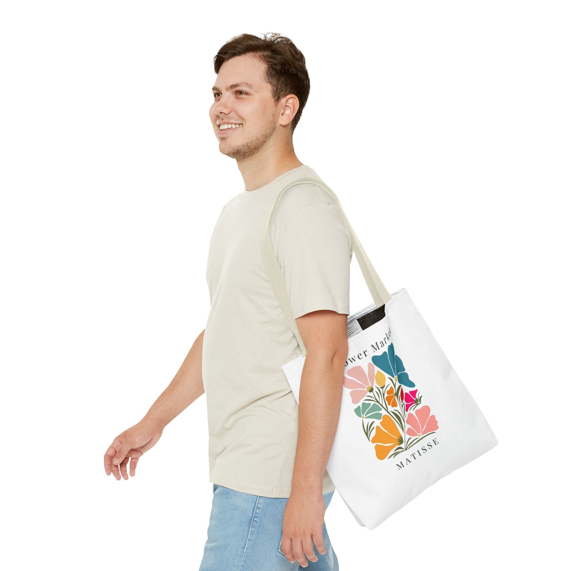 Young man carrying Henri Matisse tote bag with vibrant artistic design