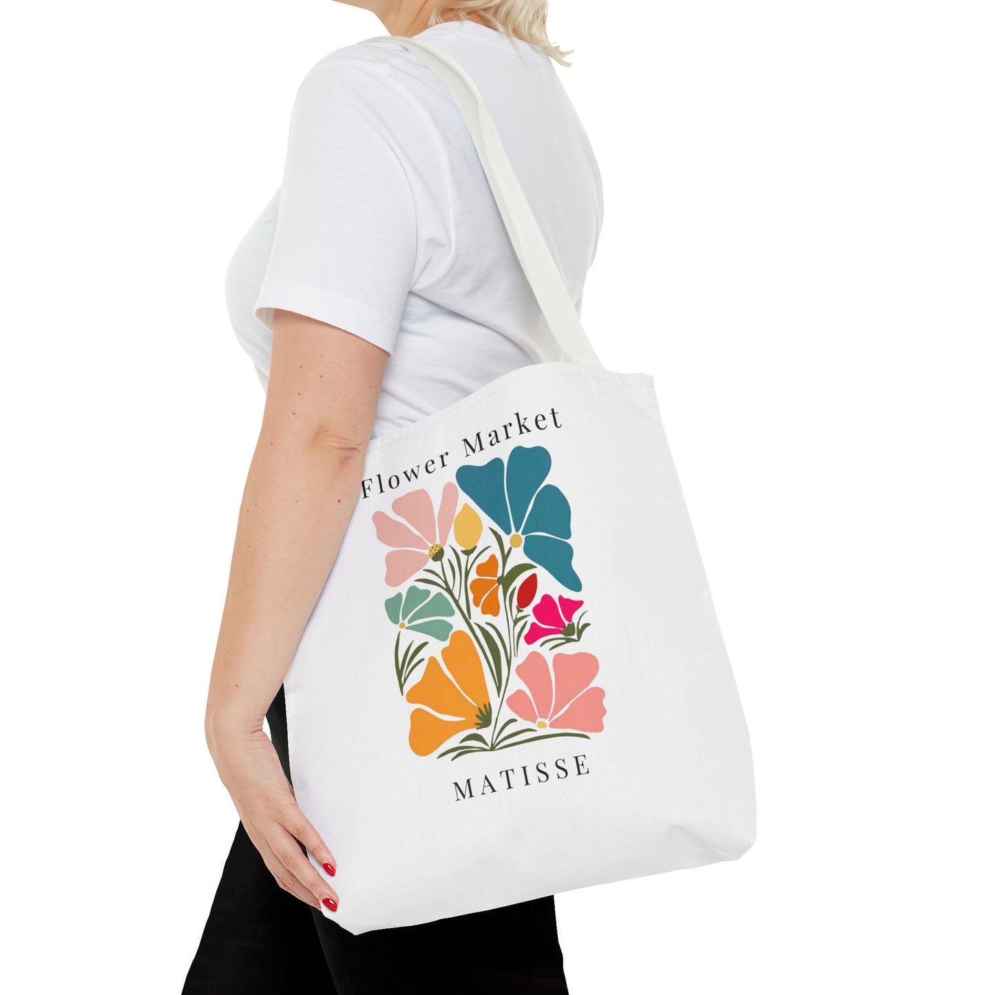 Henri Matisse tote bag featuring bold floral design carried by a woman, perfect for art lovers seeking style and practicality