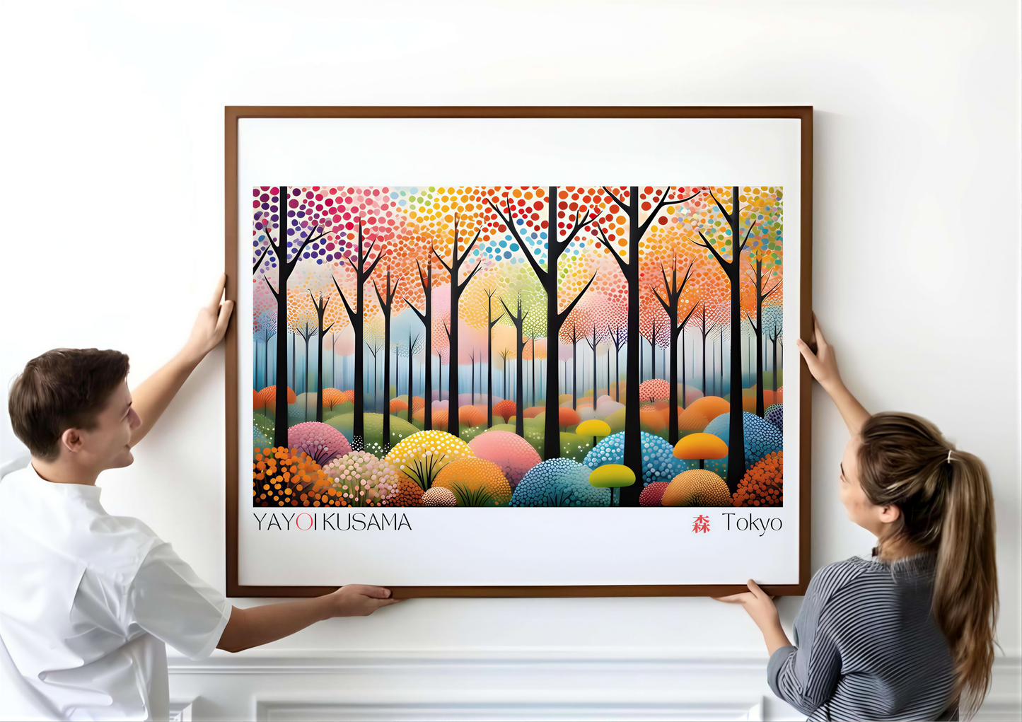 People holding a vibrant Yayoi Kusama art print featuring colorful abstract trees and polka dots.