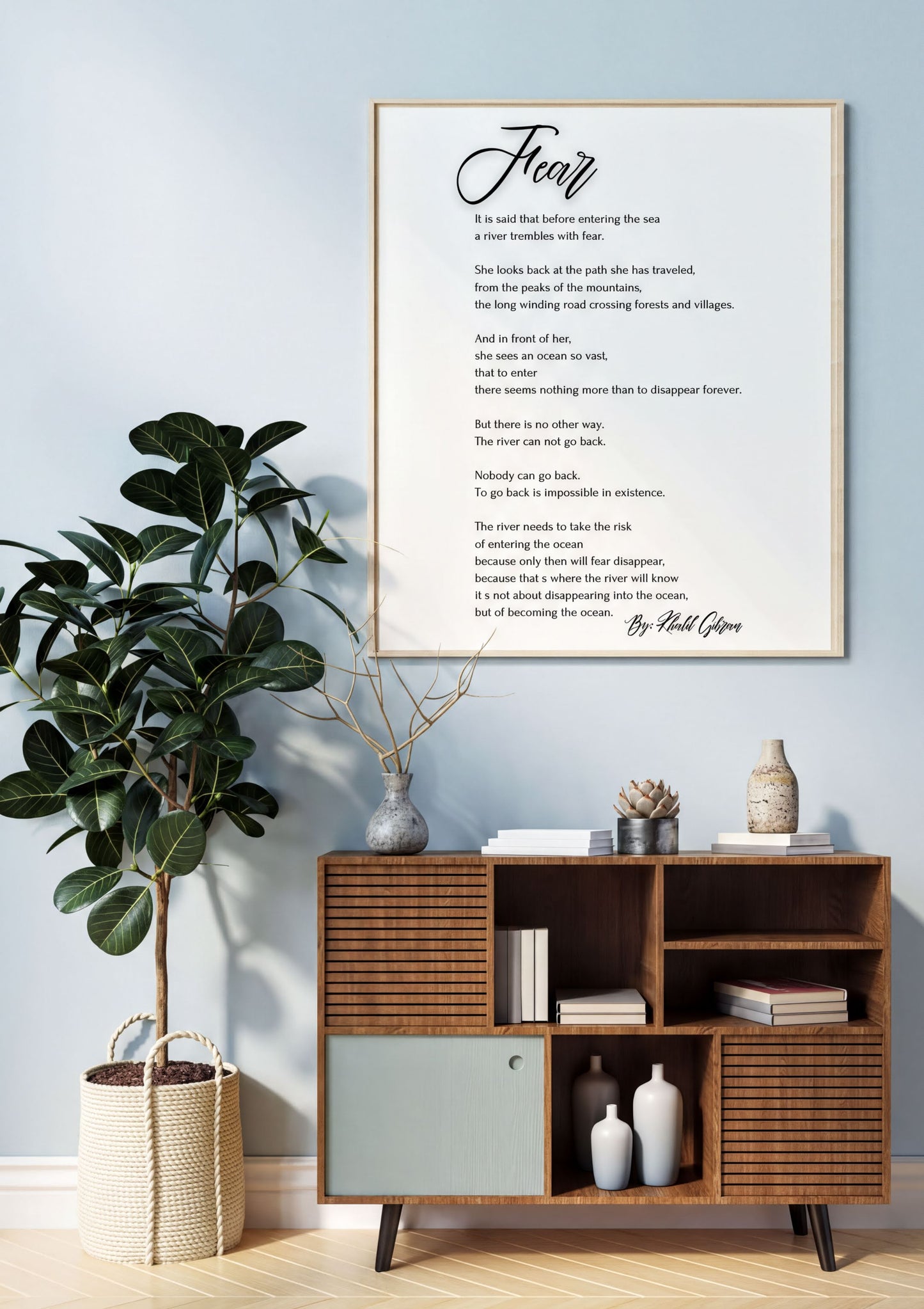 Fear - Khalil Gibran Poem Print displayed on a wall above a wooden cabinet, next to a potted plant in a modern home setting.