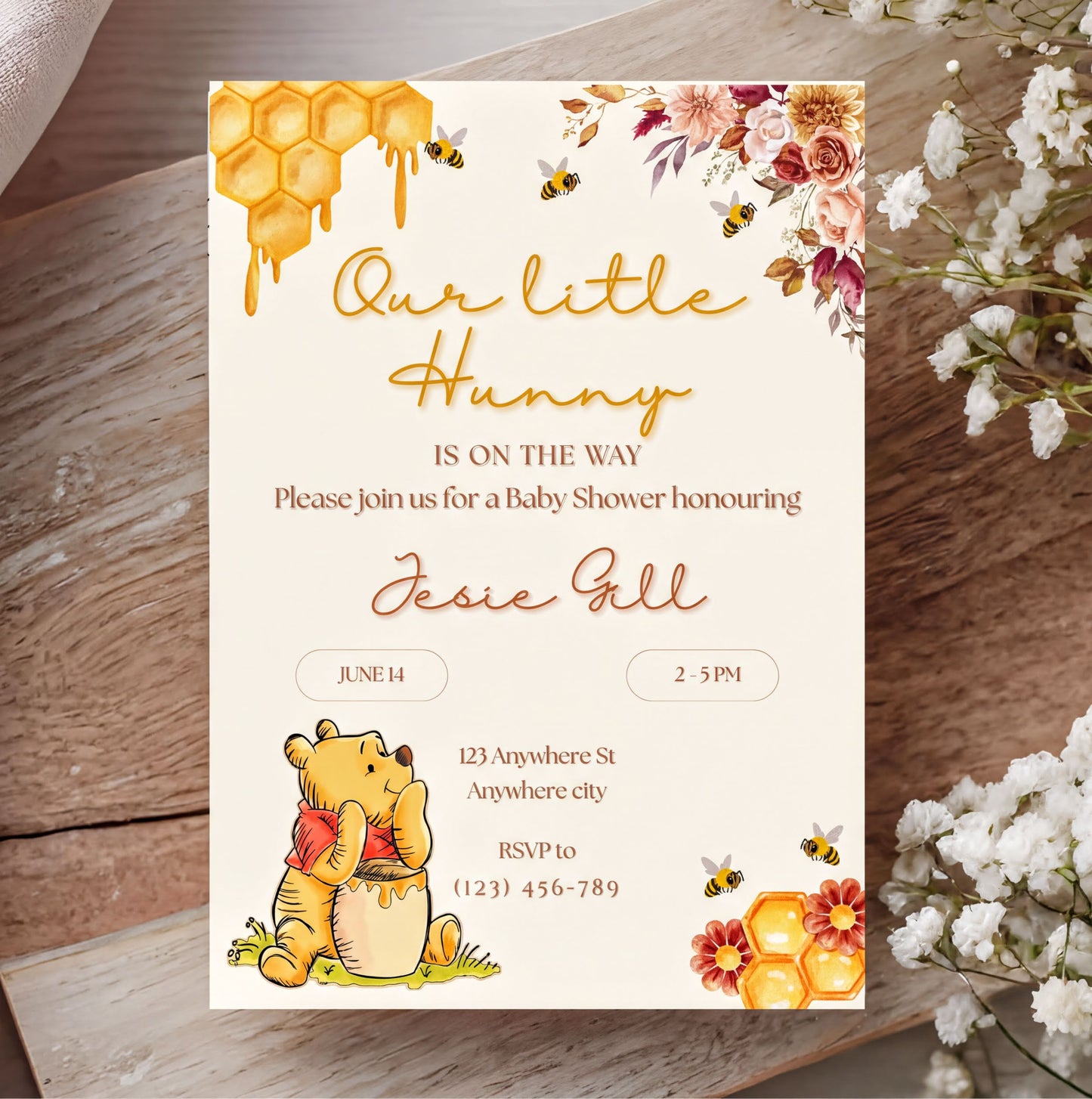 Winnie the Pooh Invitation for a baby shower with floral design and customizable text elements.