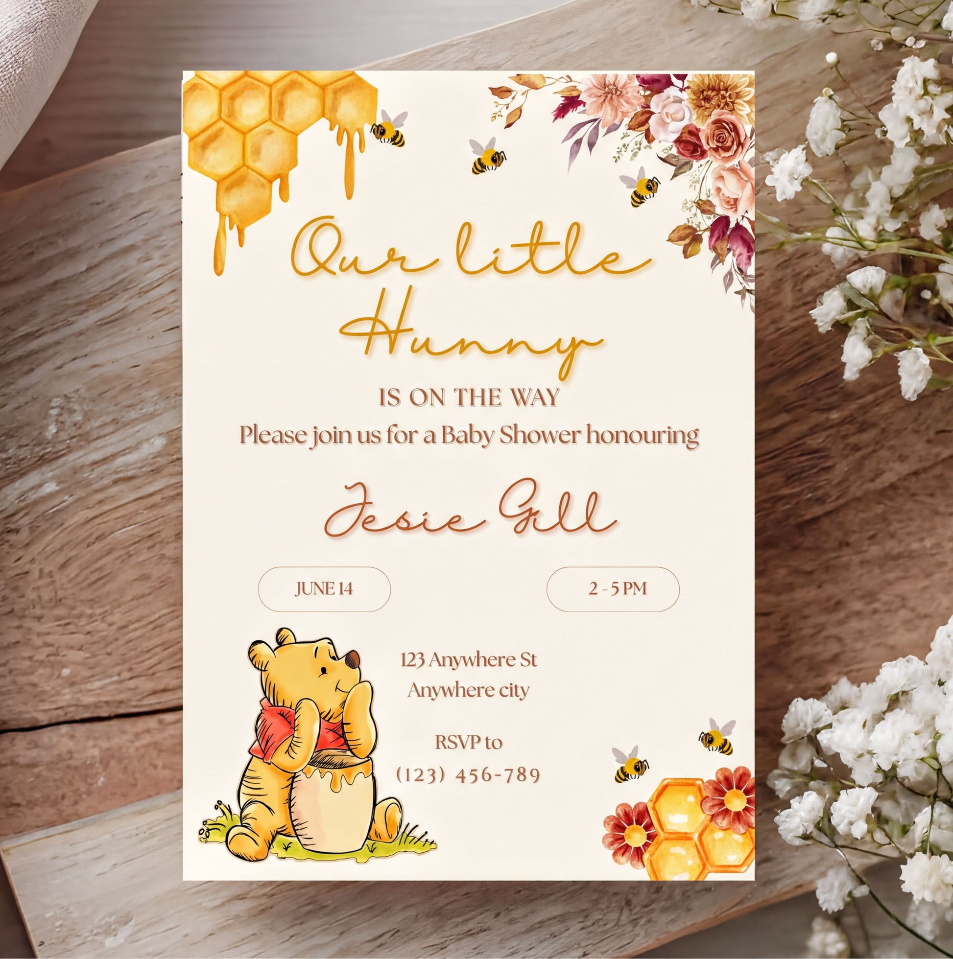 Winnie the Pooh Invitation for a baby shower with floral design and customizable text elements.