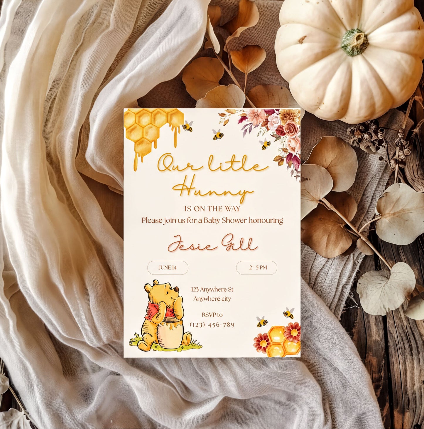 Winnie the Pooh Invitation for a baby shower featuring floral designs and honeycomb elements with customizable details.