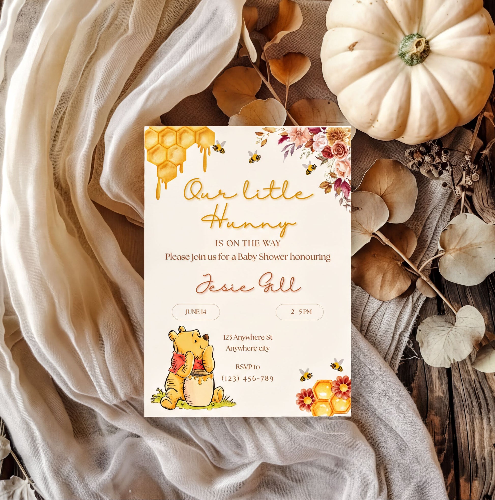Winnie the Pooh Invitation for a baby shower featuring floral designs and honeycomb elements with customizable details.