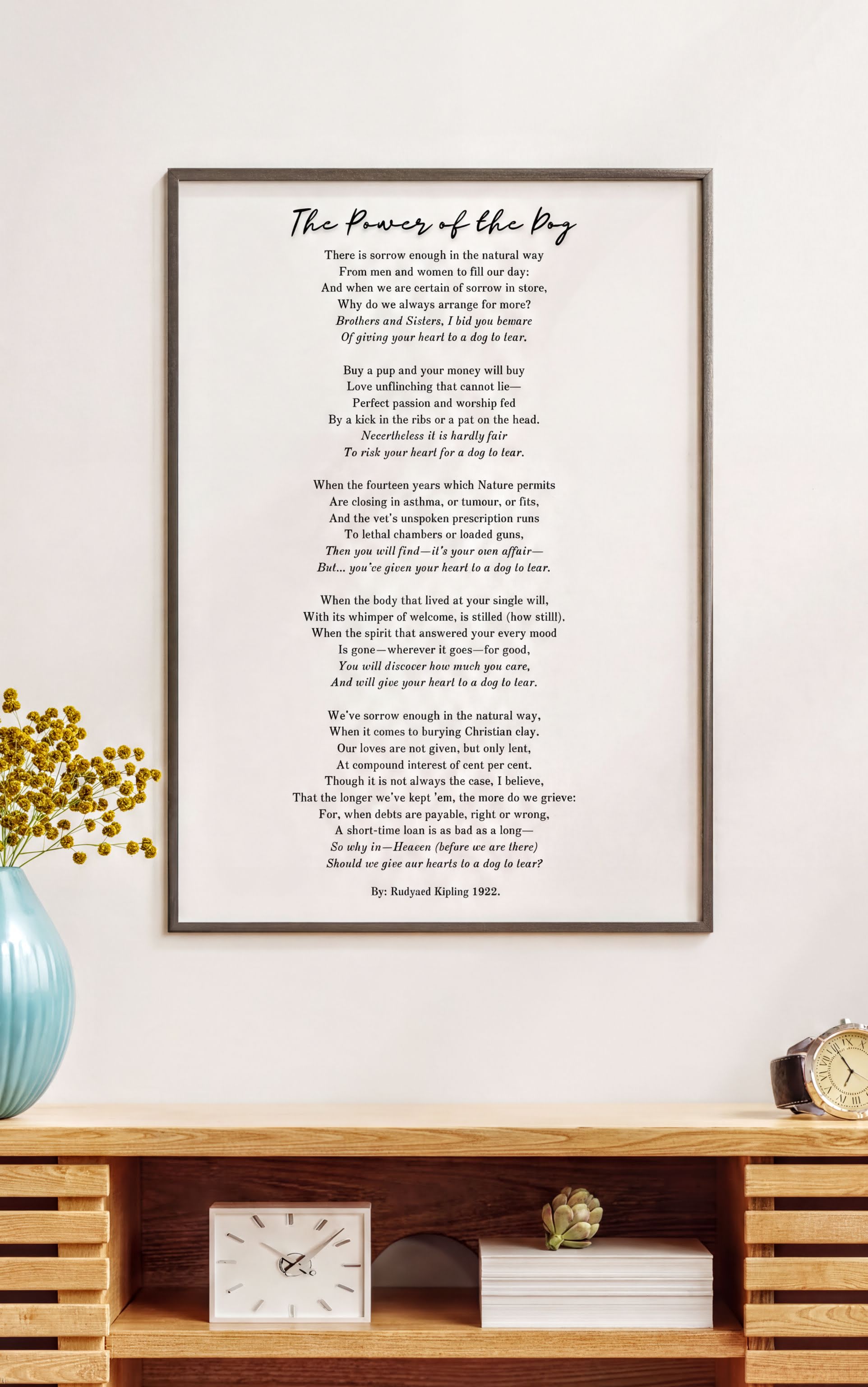 Framed art print of 'The Power of the Dog by Rudyard Kipling – Heartfelt Pet Loss Poem Print' on a wooden shelf with decor.