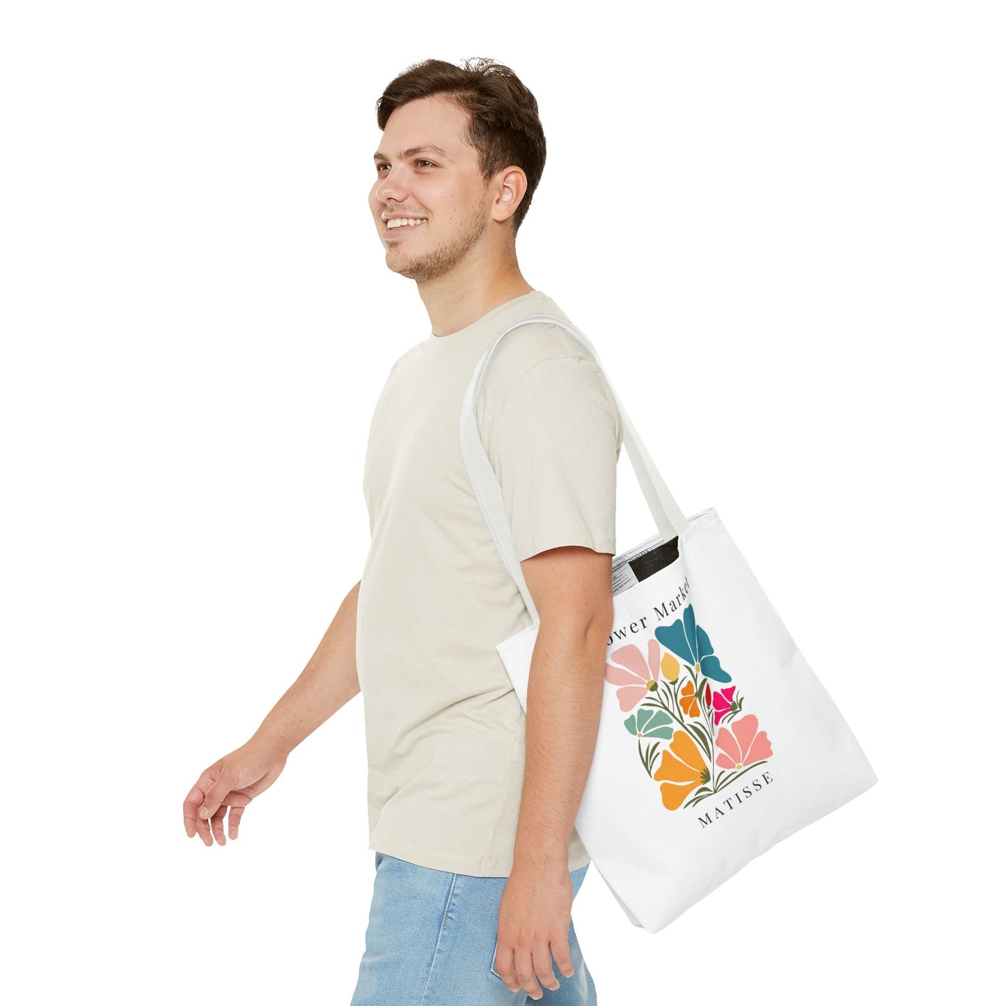 Man carrying Henri Matisse tote bag with vibrant artistic design.