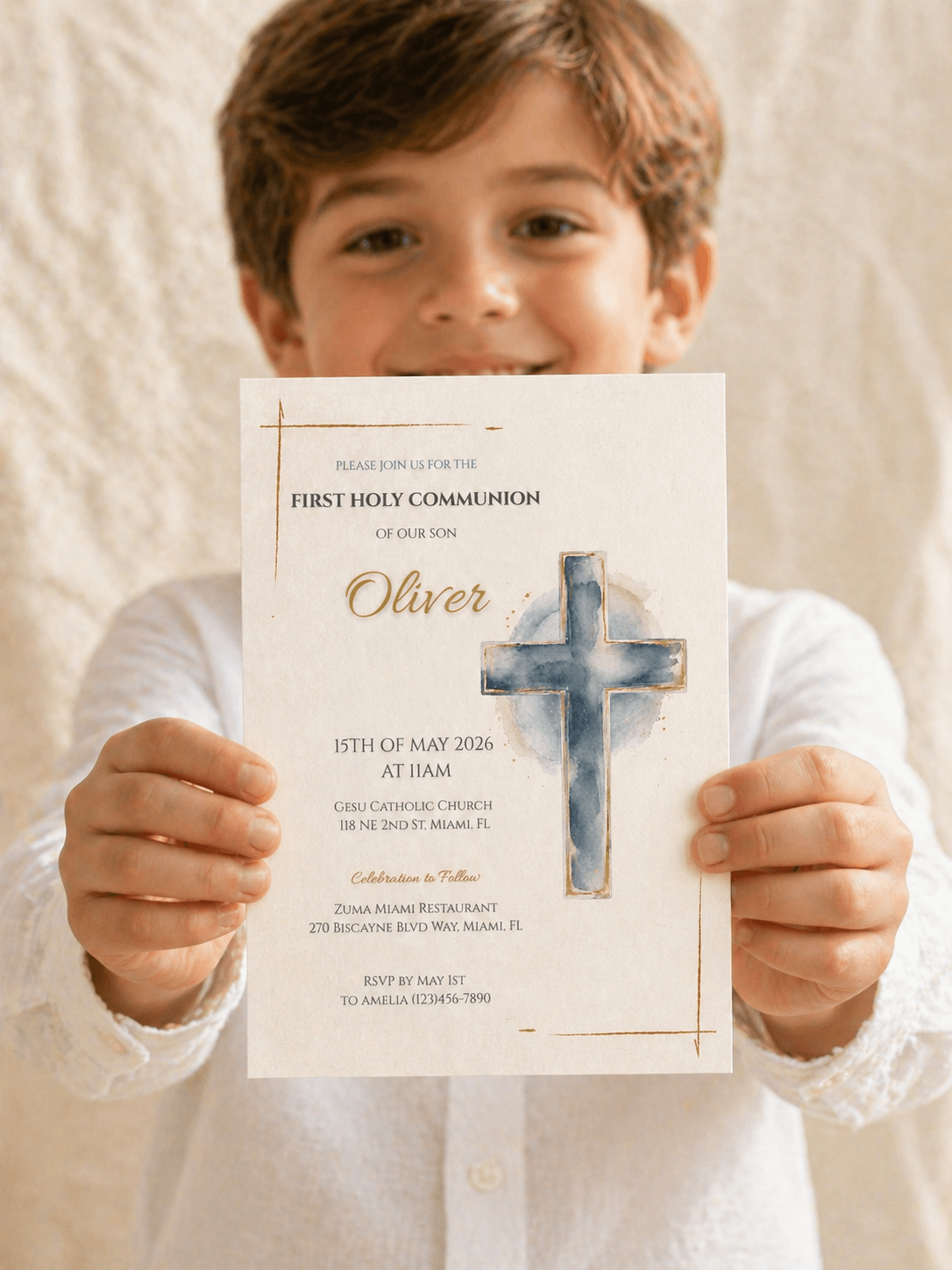 A boy holding a First Communion Invitation Printable featuring a blue cross and details for the event on May 15, 2026.