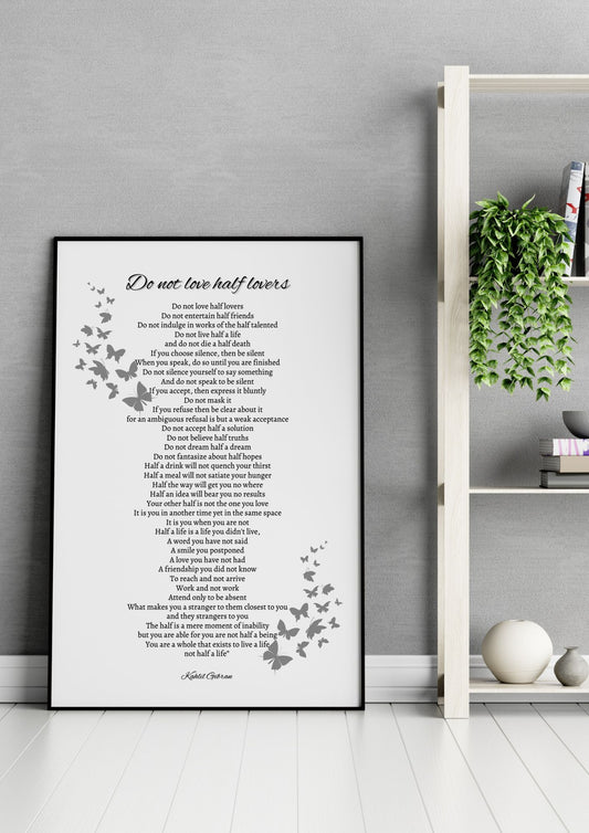 Do Not Love Half Lovers – Kahlil Gibran Poem Print in a minimalist black and white design, displayed on a floor beside a white shelf.