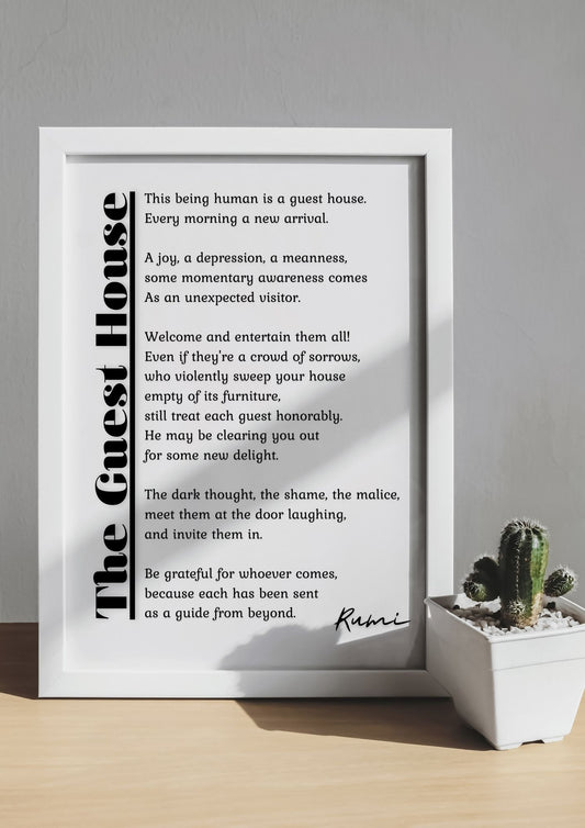 Framed 'The Guest House by Rumi – Mindfulness Poetry Printable Wall Art' with a small cactus plant on a sunlit table.