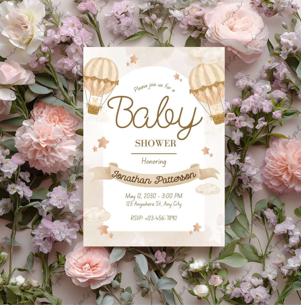 Beige baby shower invitation with hot air balloon design surrounded by pink and white flowers.