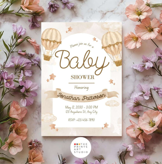 Beige baby shower invitation with hot air balloon design and floral accents.