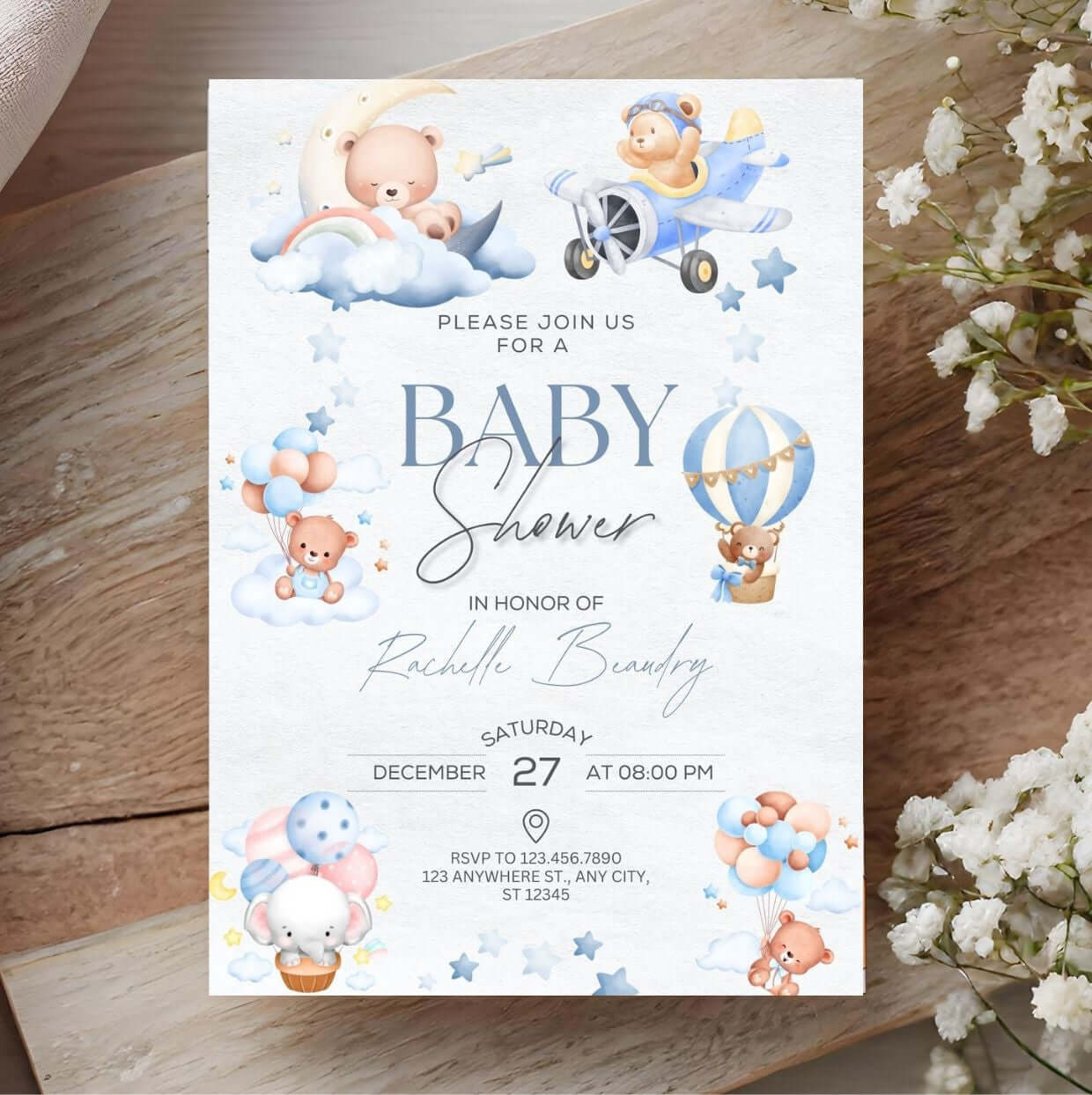 Cute baby shower invitation with teddy bears, clouds, and balloons design on a rustic wooden background, including floral accents.