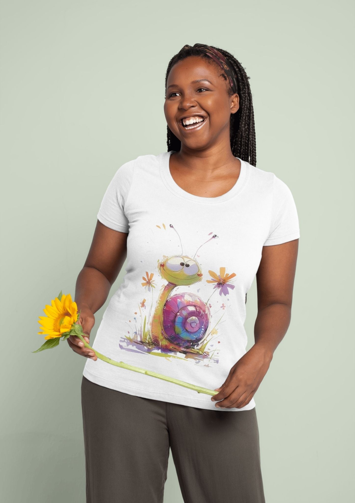 Woman wearing Cute Snail T-Shirt Design – Whimsical Colorful Snail Graphic, holding a sunflower, enjoying nature-inspired fashion.