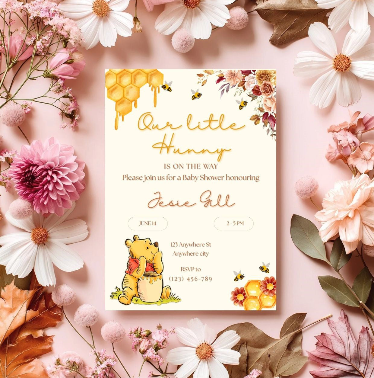 Winnie the Pooh baby shower invitation template with floral border and honeycomb design, featuring beloved storybook character.