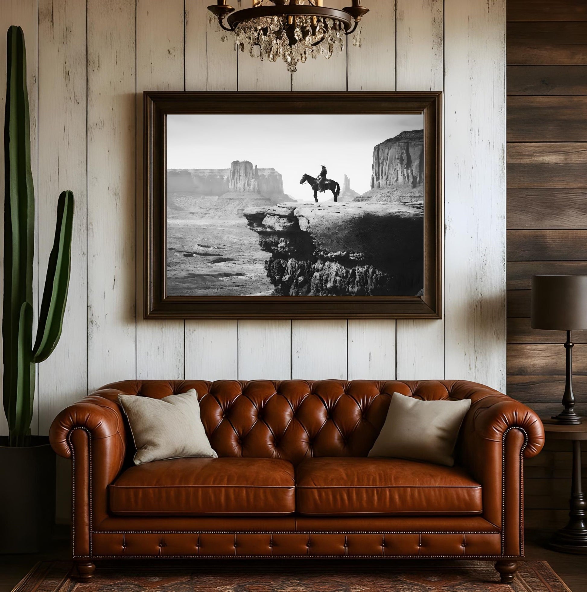 Western Wall Art Print - Black and White Cowboy Landscape above a leather sofa in a rustic living room