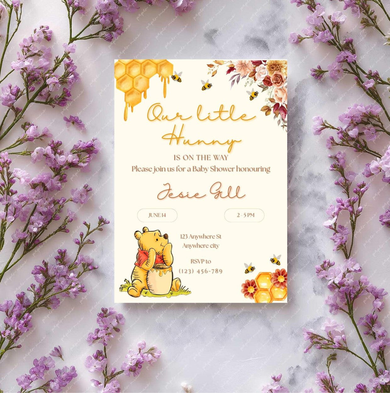 Winnie the Pooh baby shower invitation template surrounded by purple flowers, featuring honeycomb and floral design.