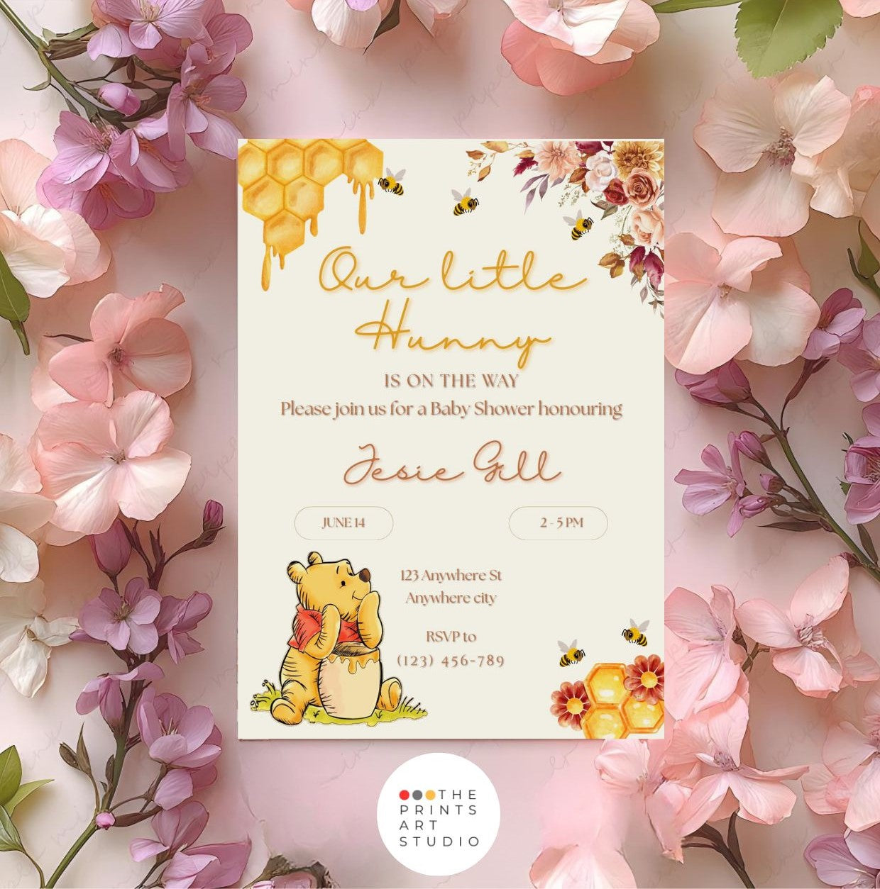 Winnie the Pooh baby shower invitation with floral border and honeycomb design on a floral background.