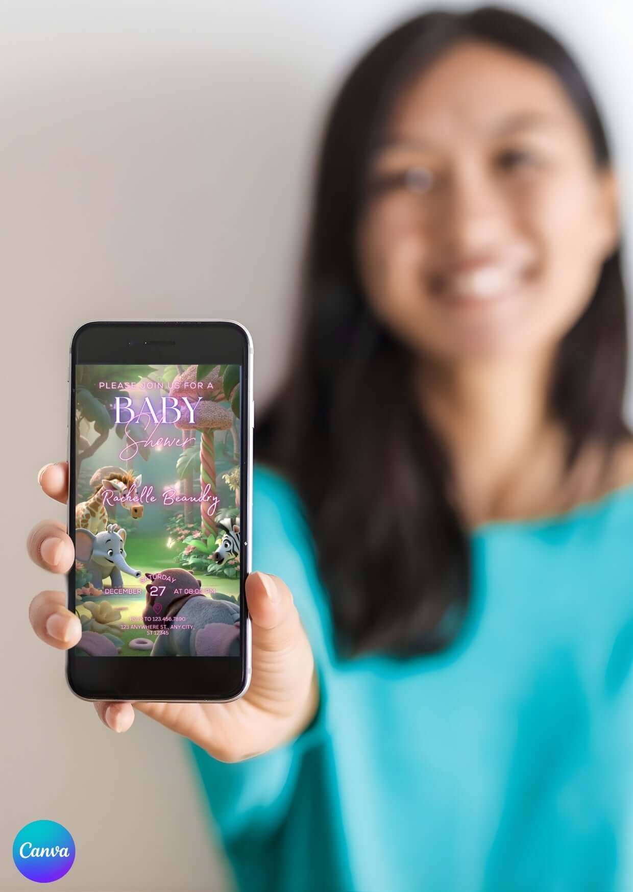 Woman holding smartphone displaying Editable Baby Shower Video Invitation Template | Canva Digital Invite with jungle theme