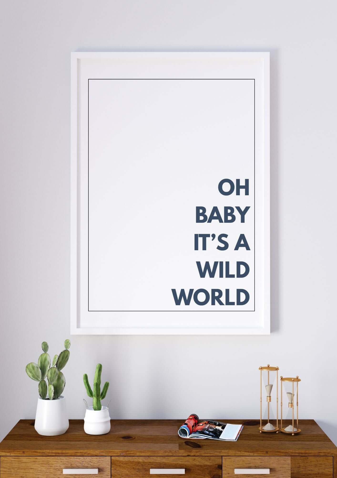 oh baby its a wild world wall art in a minimalist frame, displayed on a wooden console with plants and books