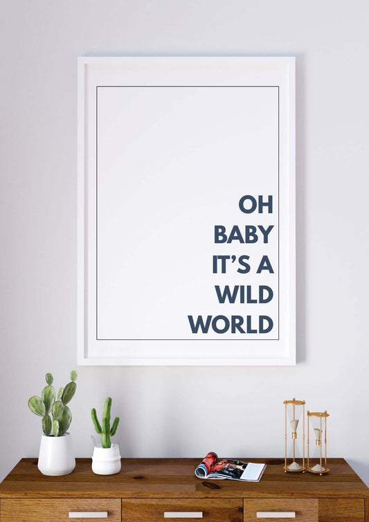Minimal wall art featuring "Oh Baby It’s a Wild World" quote print in a modern home setting with decor accents.