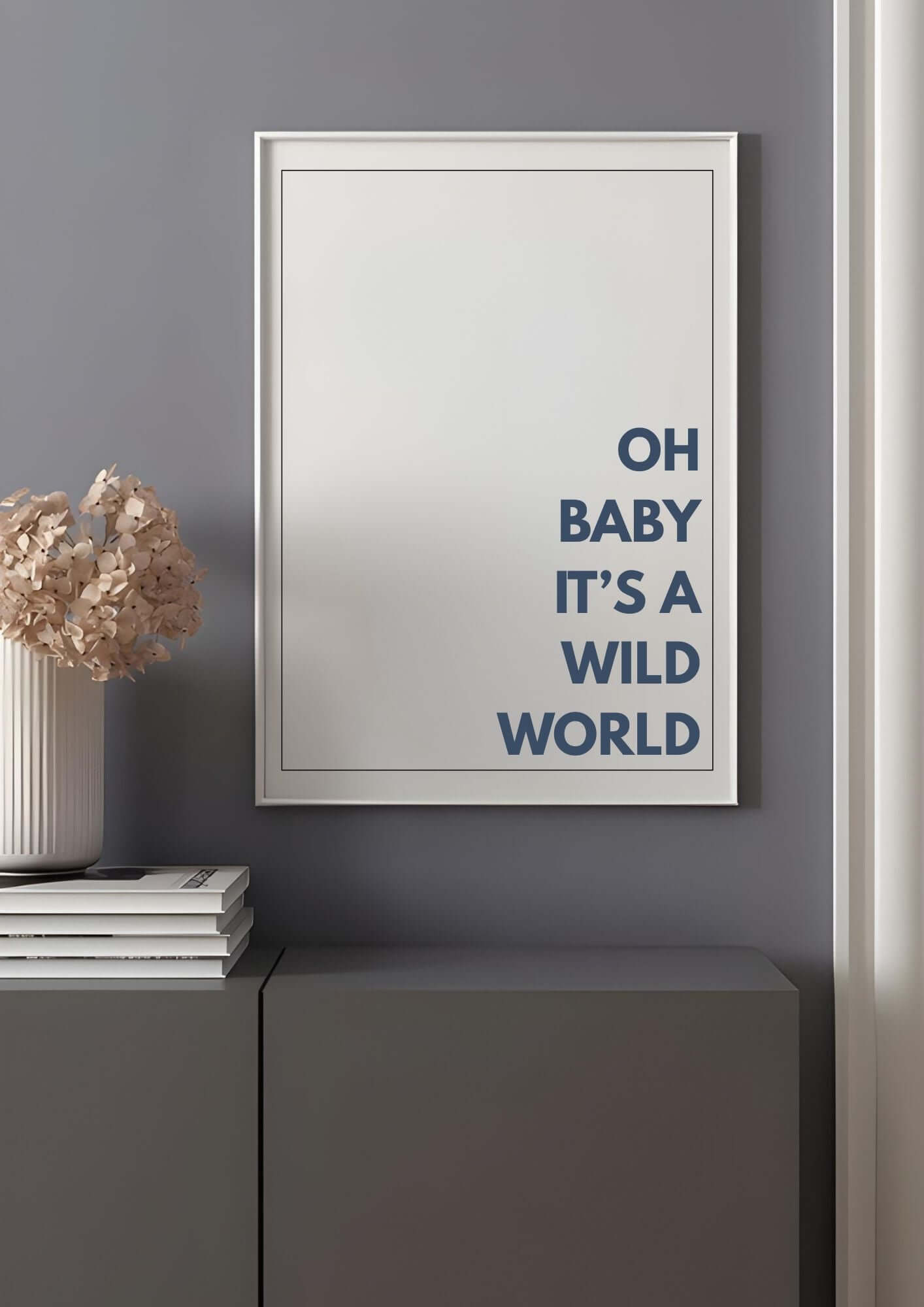 oh baby its a wild world wall art in minimalist typography, framed and displayed in a modern living room setting with neutral tones