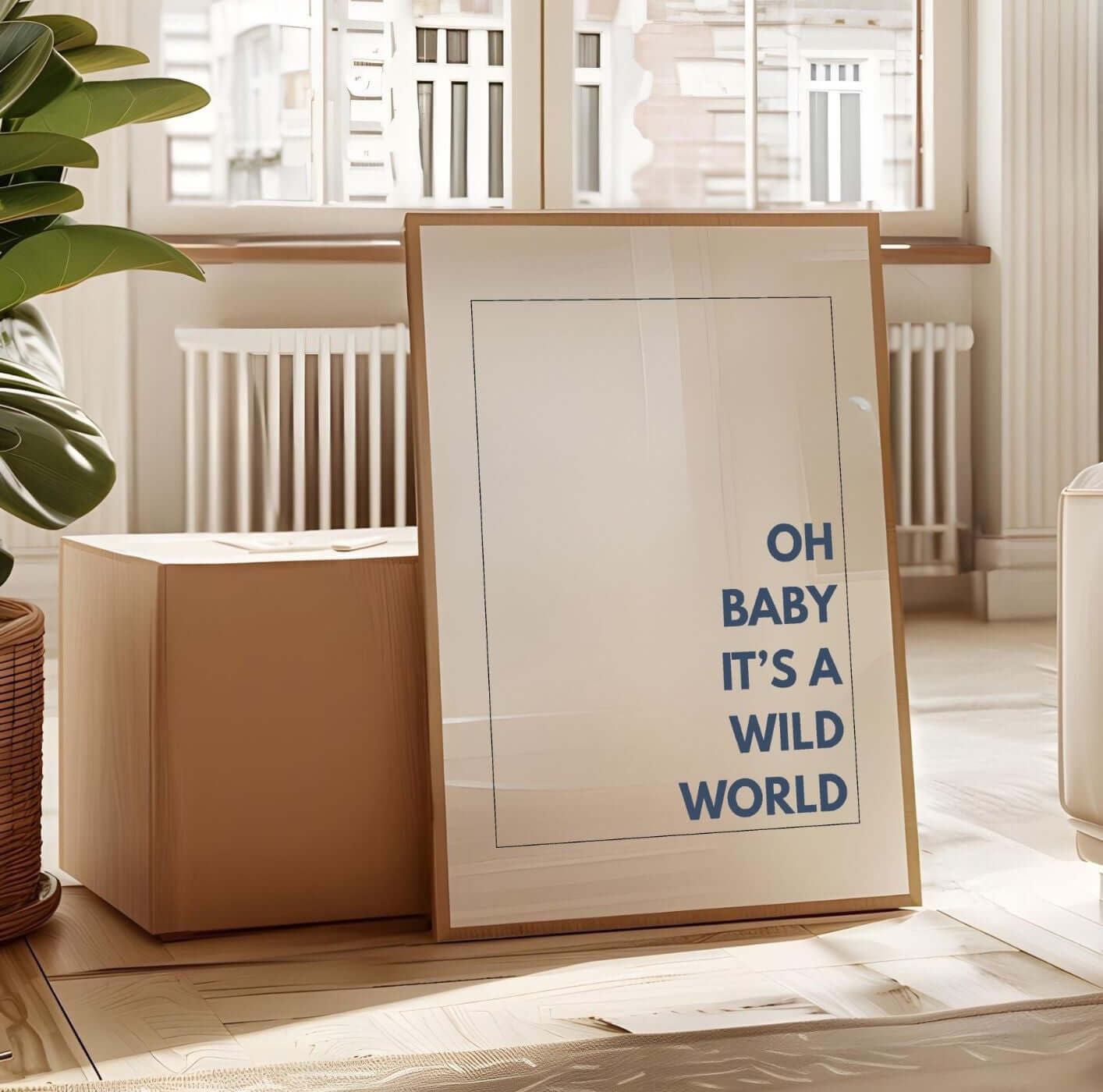 Modern "Oh Baby It’s a Wild World Quote Print" minimal wall art leaning against a wall in a bright room with plants and sunlight.