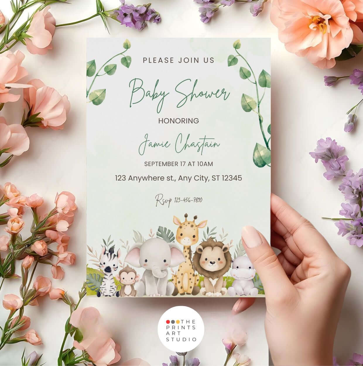 Safari baby shower invitation with jungle animals and greenery held by hands, surrounded by flowers, featuring elephants, giraffes, and lions.
