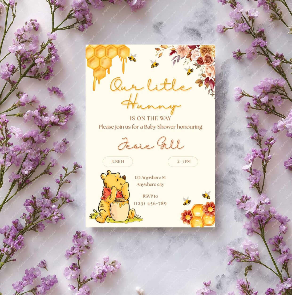 Winnie the Pooh baby shower invitation template surrounded by purple flowers, featuring honeycomb and floral design.