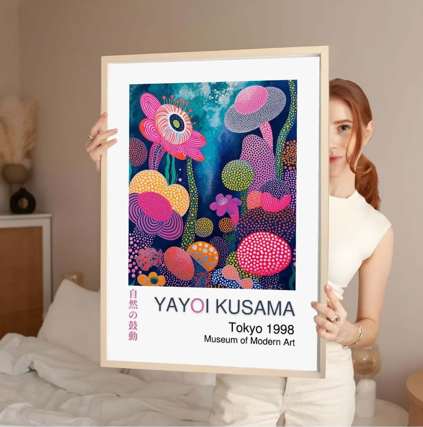 Woman holding a Yayoi Kusama digital art print, featuring colorful floral patterns with a museum label, promoting digital download options.